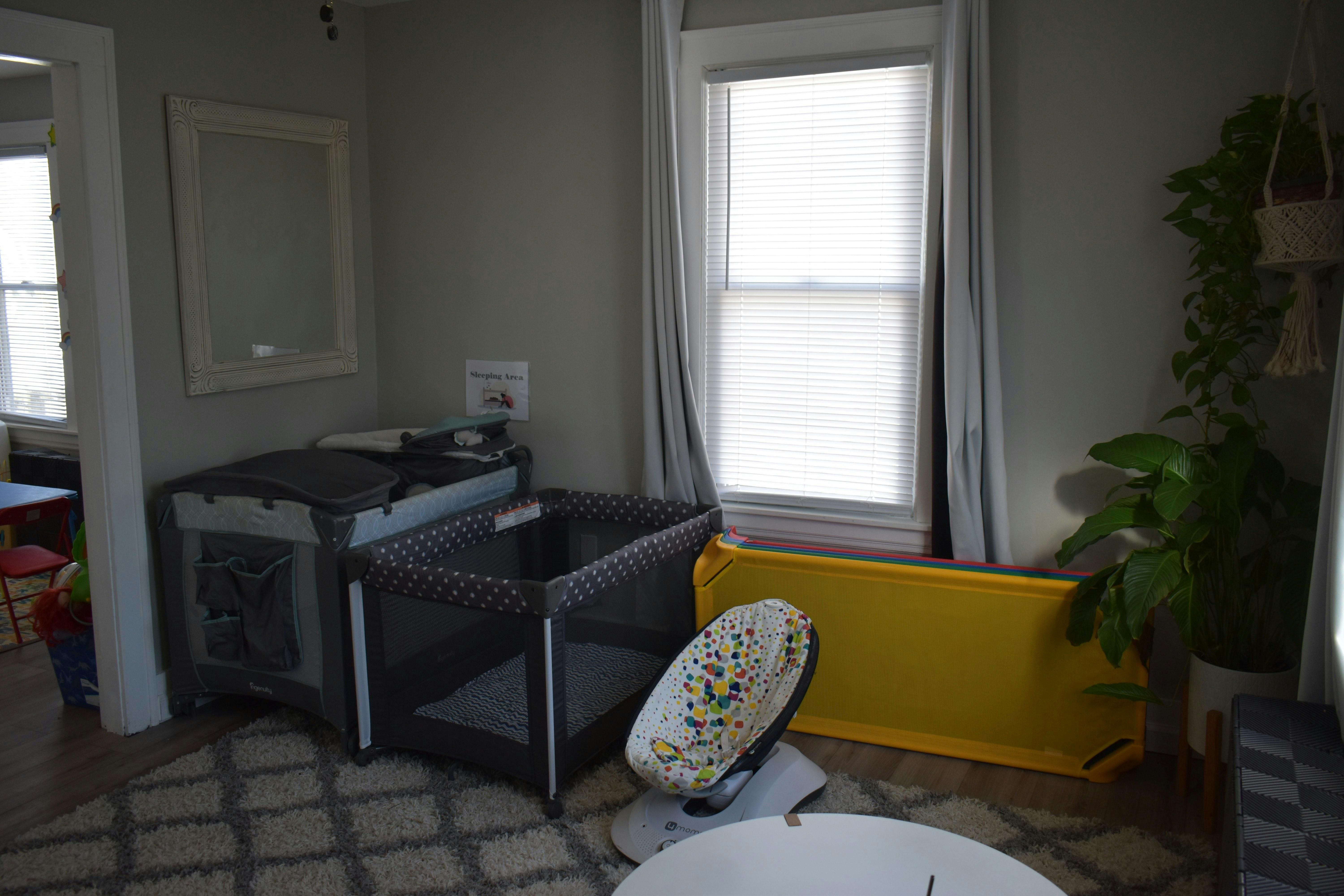 Playpen and changing table in a room