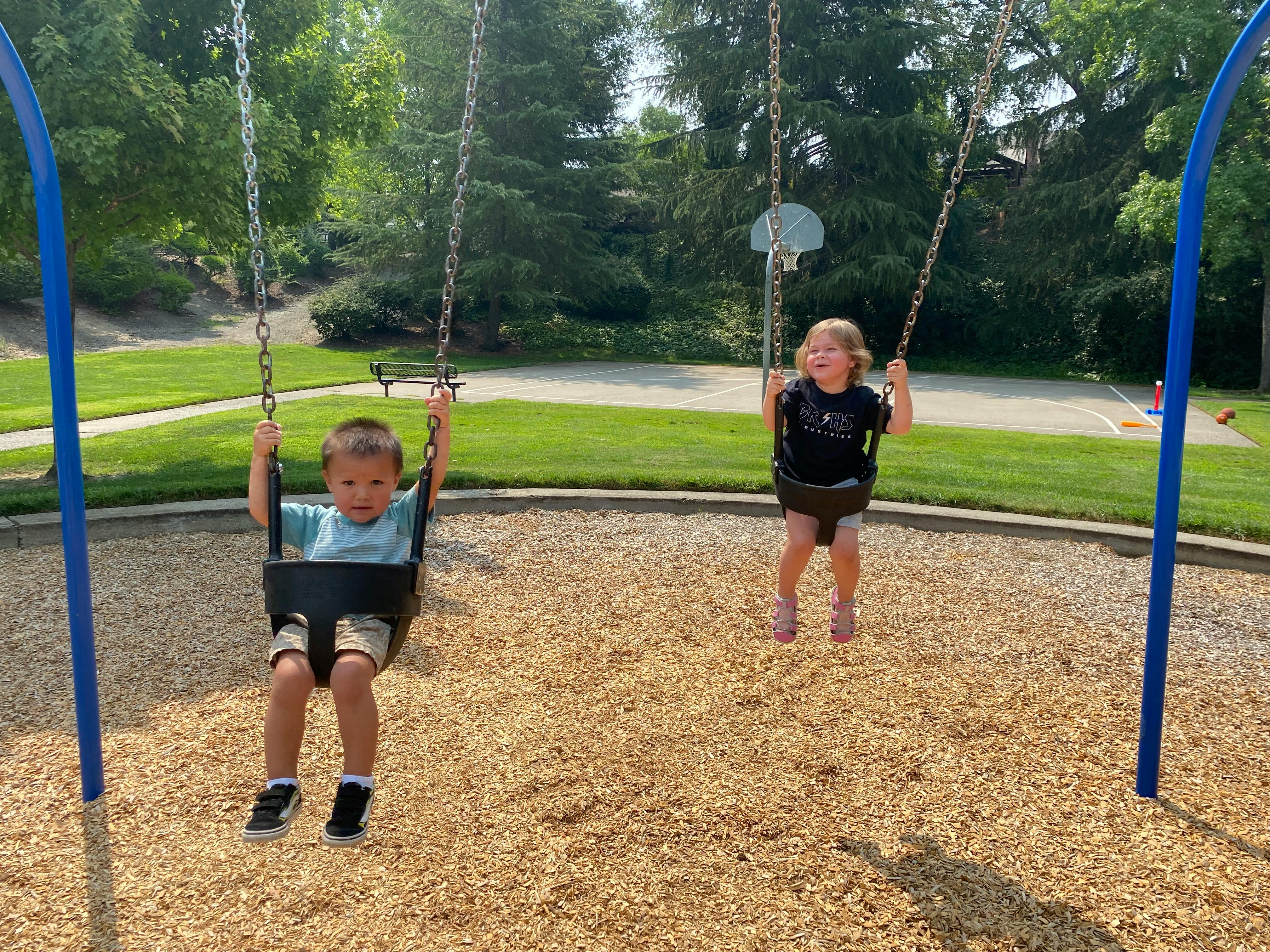Two children on swings at a playground