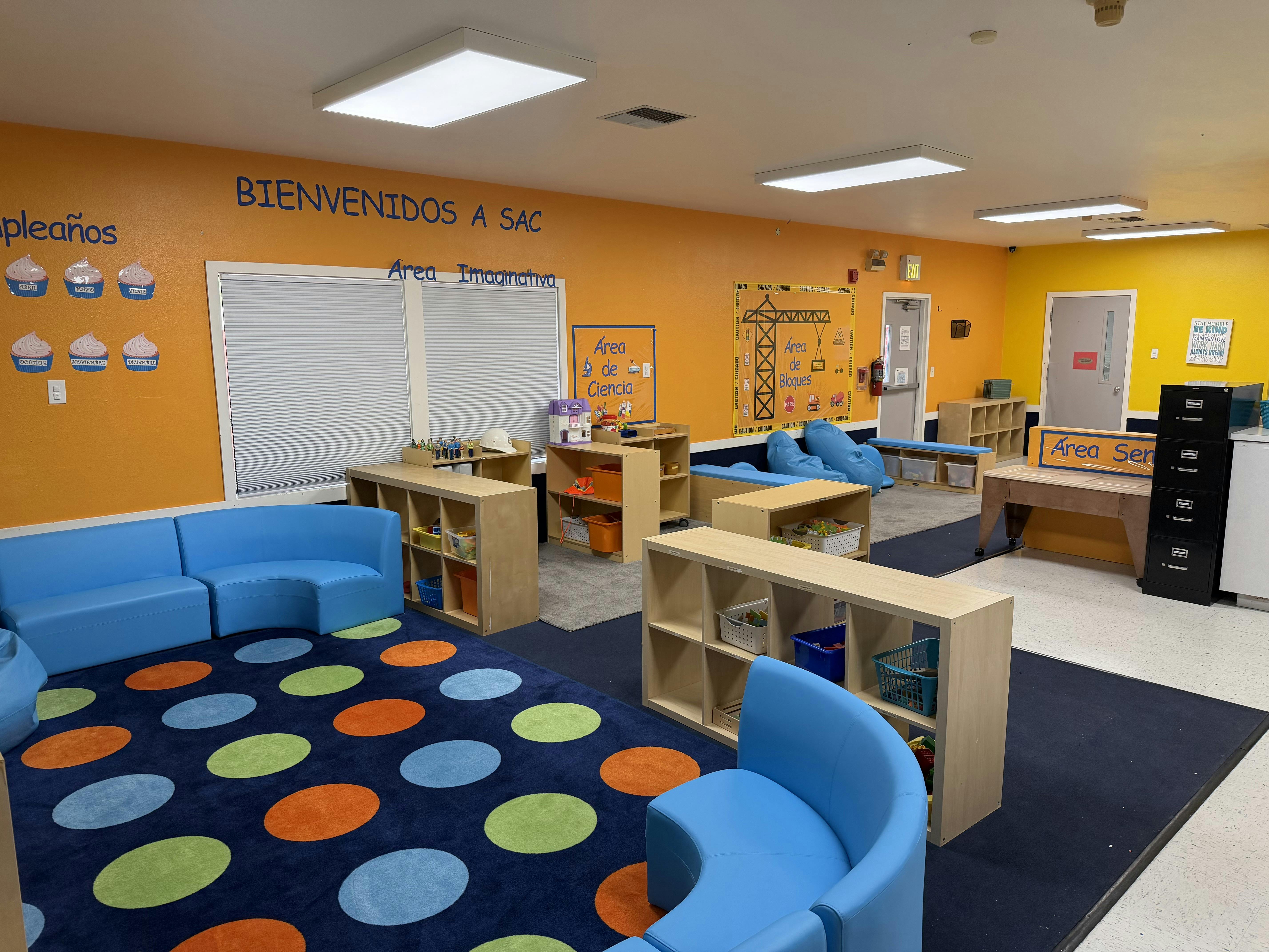 Colorful preschool classroom with modular furniture and a polka dot rug
