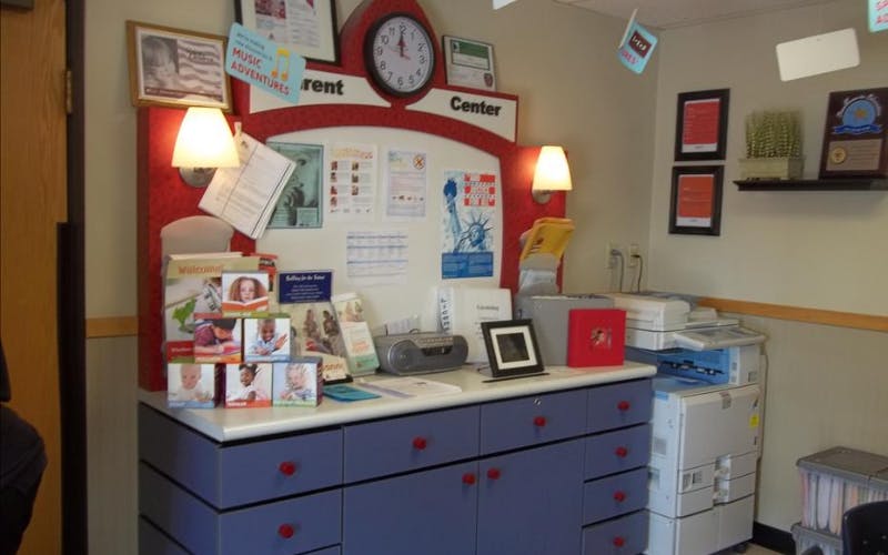 Parent Center display with pamphlets, clock, and documents, a large blue cabinet
