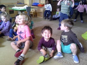 Children sitting on the floor in a classroom