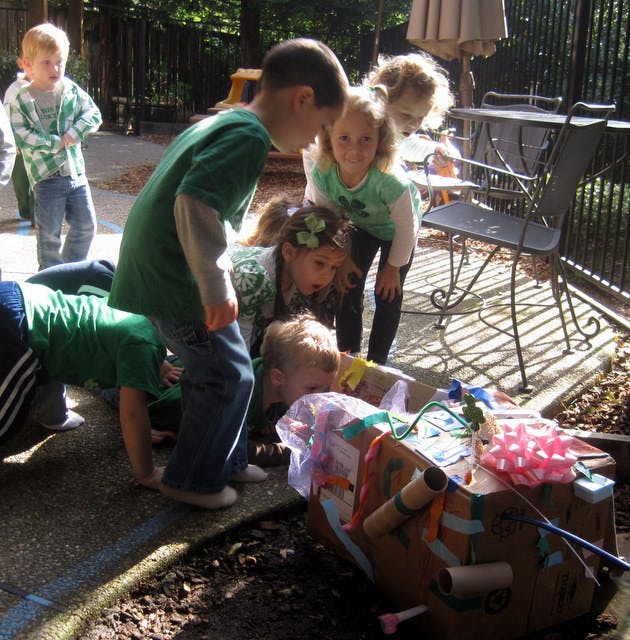 Children gathered around a decorated cardboard box