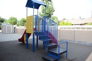 Playground structure with slide and stairs