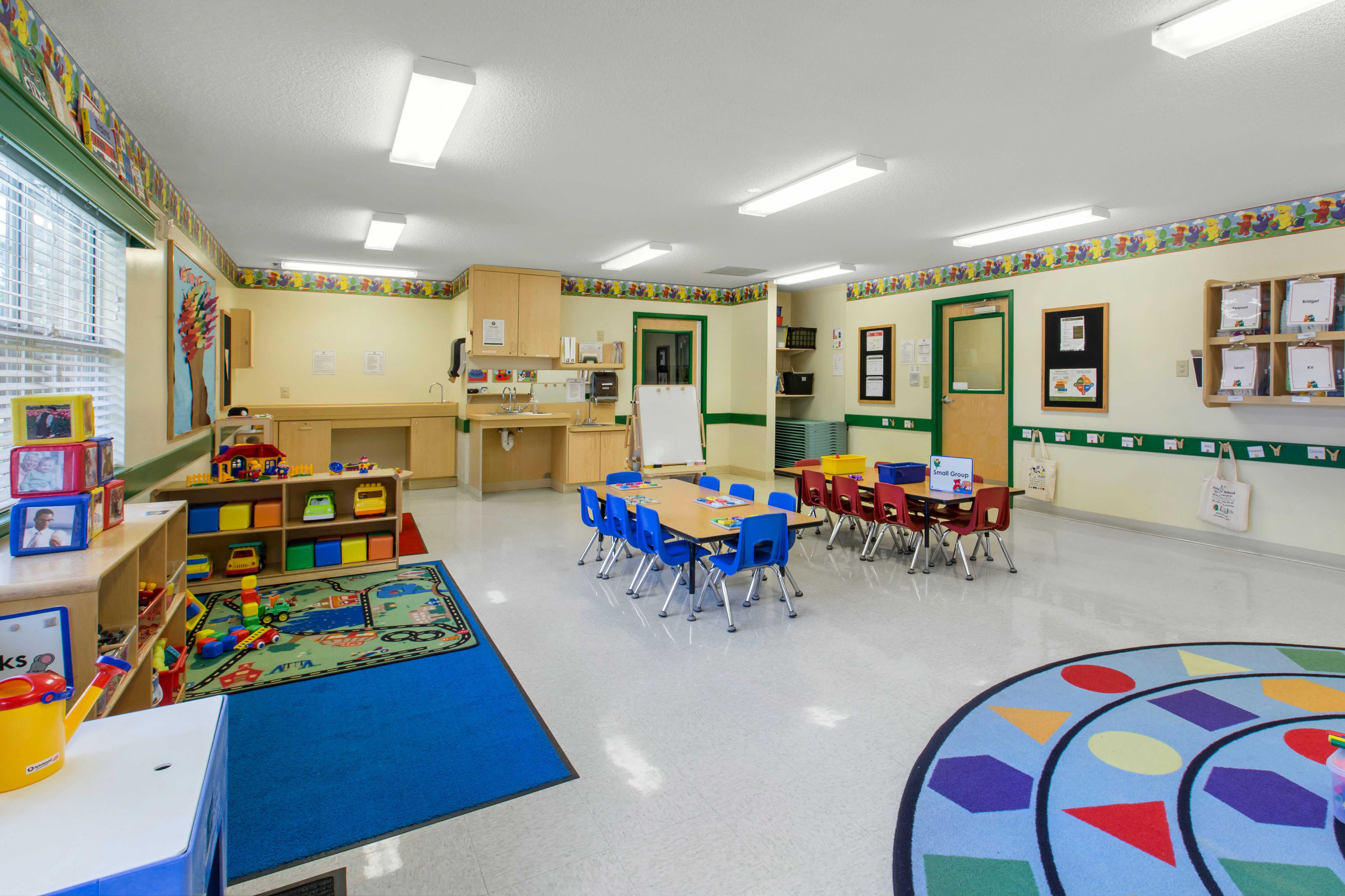 Empty colorful classroom with small tables and chairs