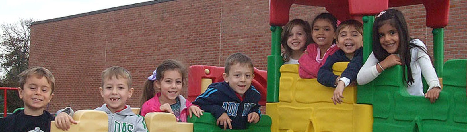 Group of children playing on playground equipment