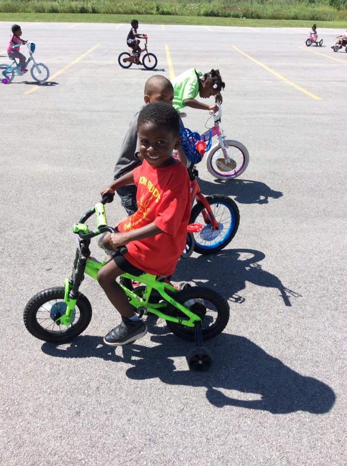 Children riding bicycles on pavement