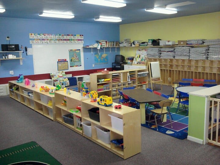 Classroom with shelves of toys and small tables and chairs