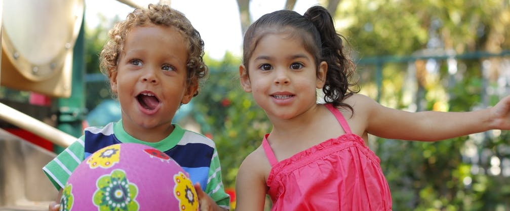 Two children, one holding a ball