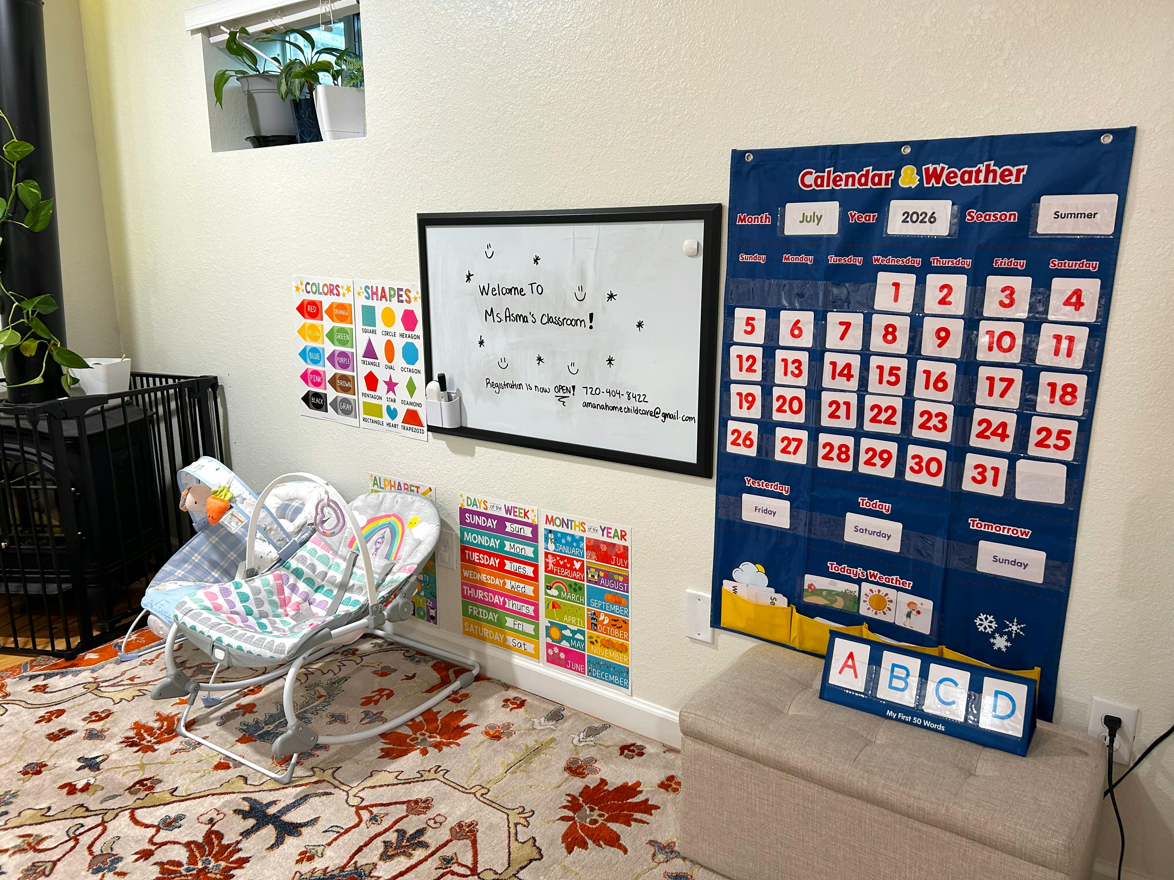 Educational wall charts and a baby bouncer in a childcare room