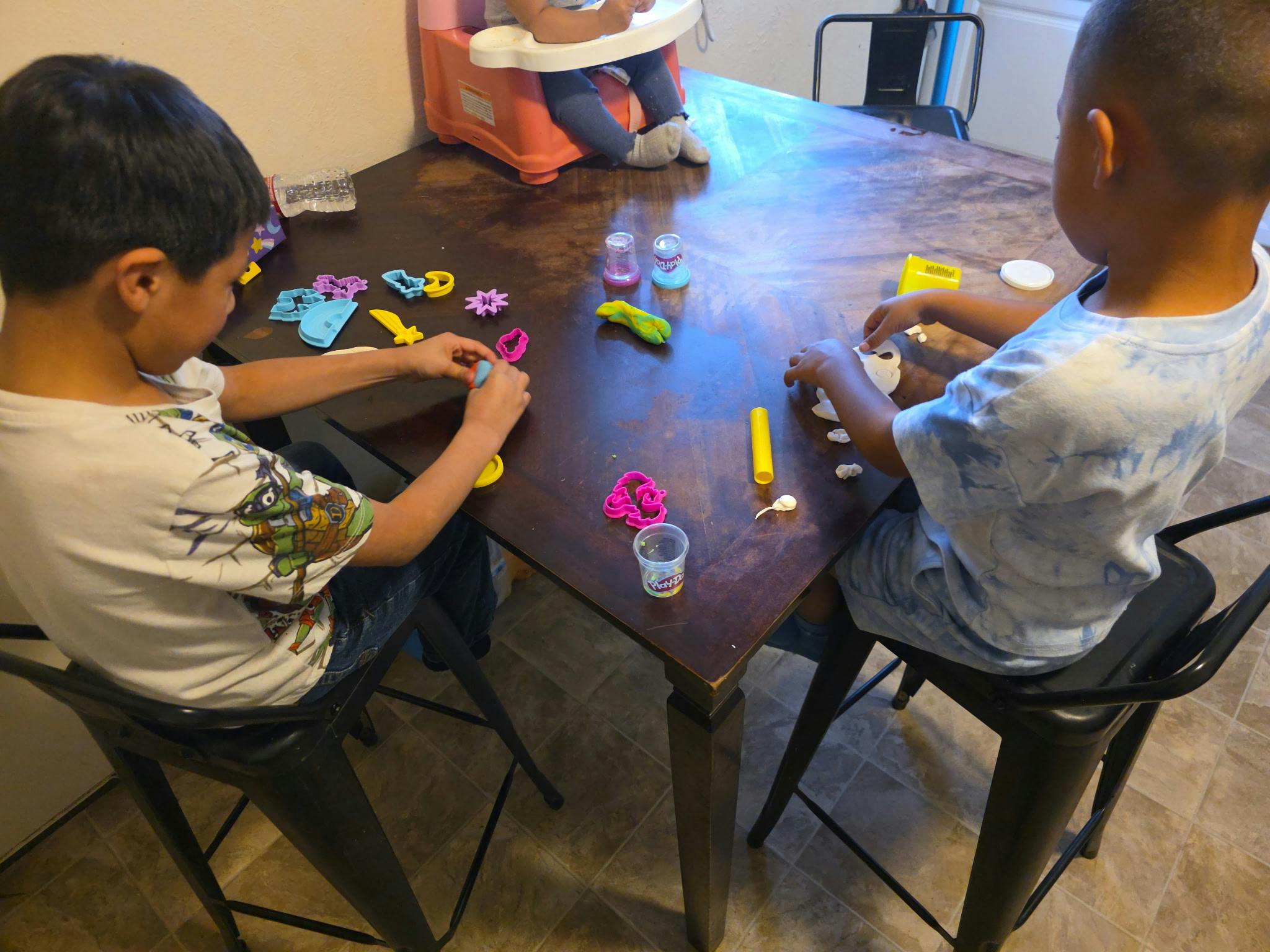 Children playing with modeling clay at a table