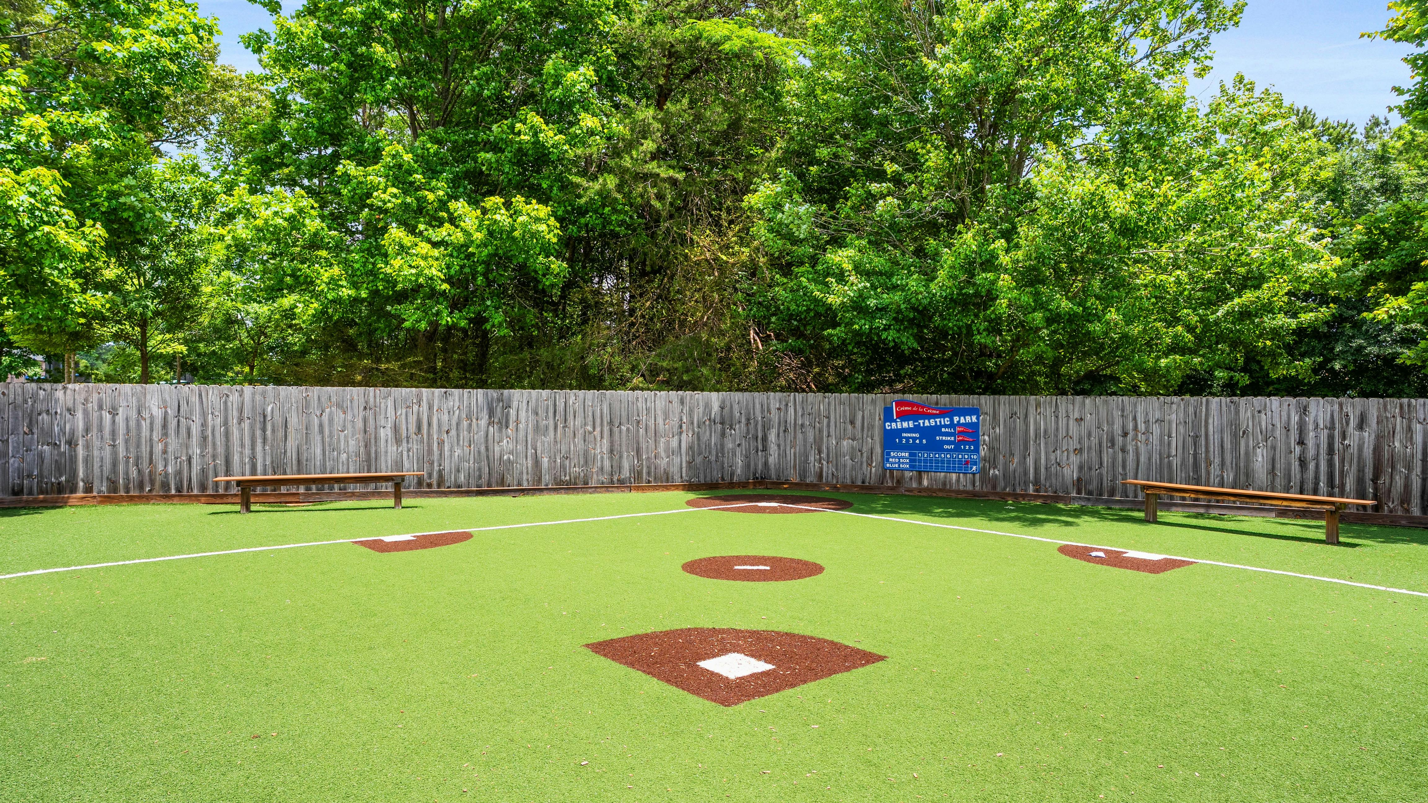 A miniature baseball field with a scoreboard reading "Creme-Tastic Park"