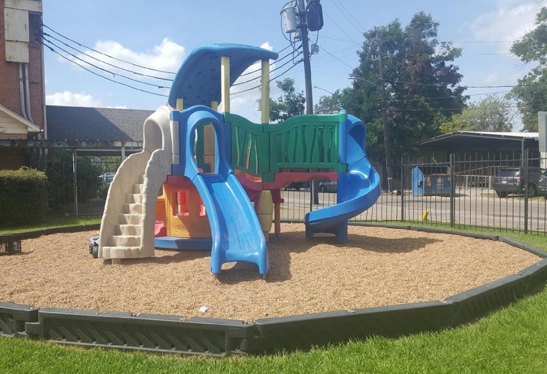 Playground with slides and climbing structure on wood chips