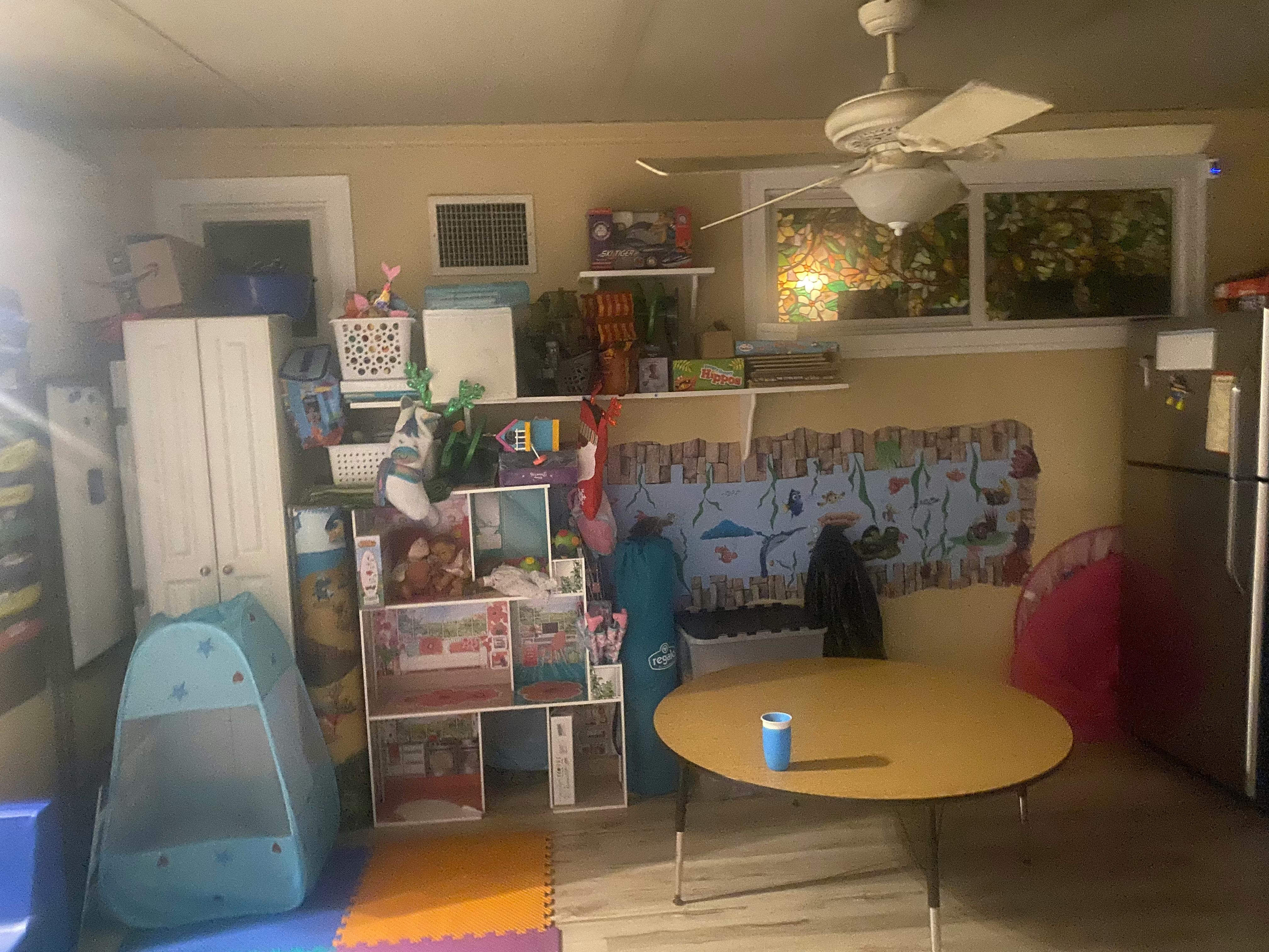 Room with a table, shelves, and various items