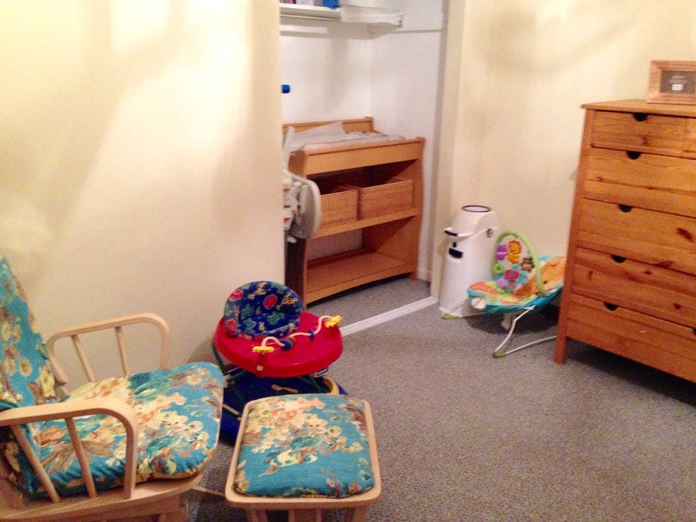 Nursery room with changing table, dresser, and baby items