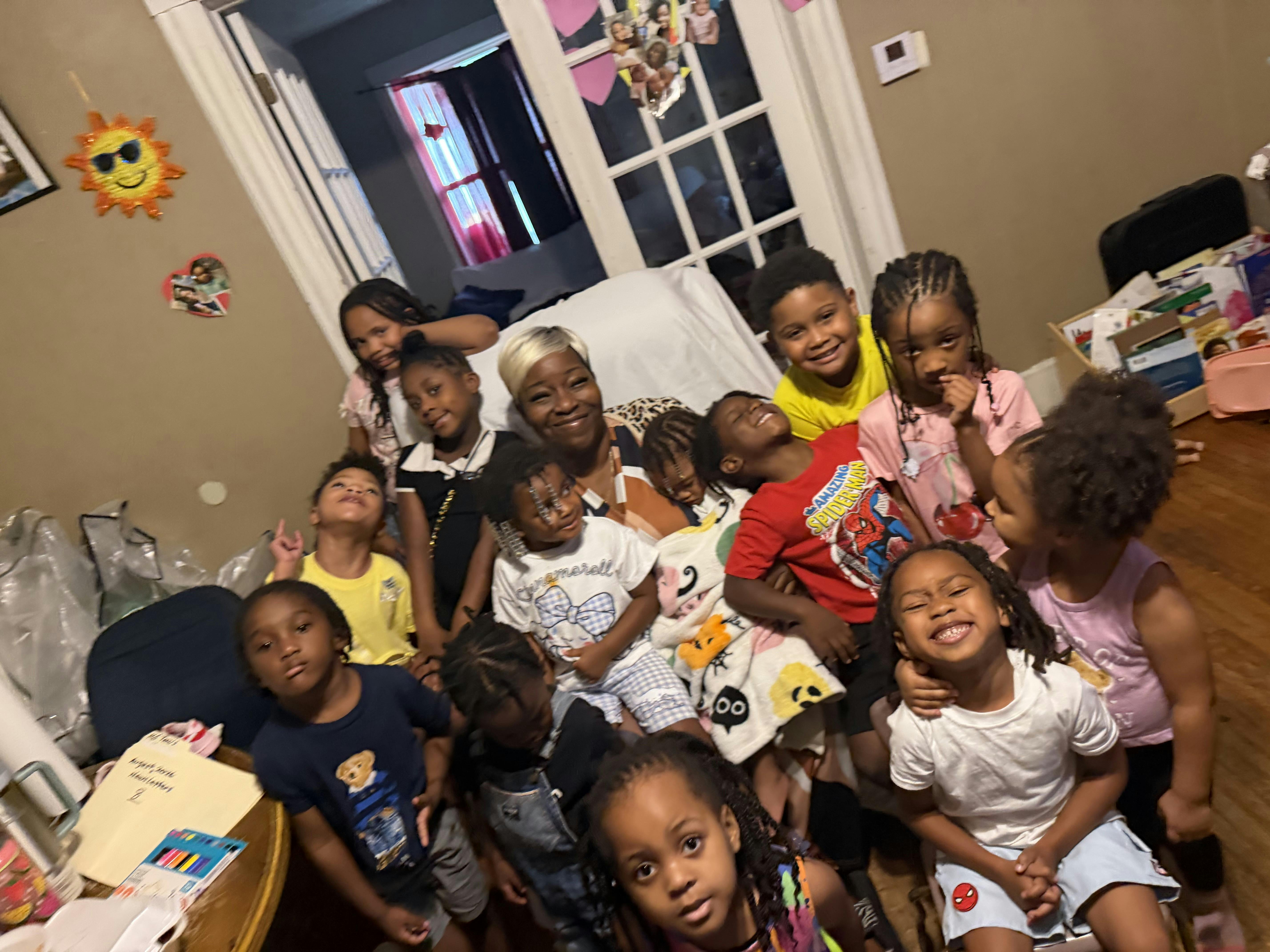 Group of children and an adult posing together indoors