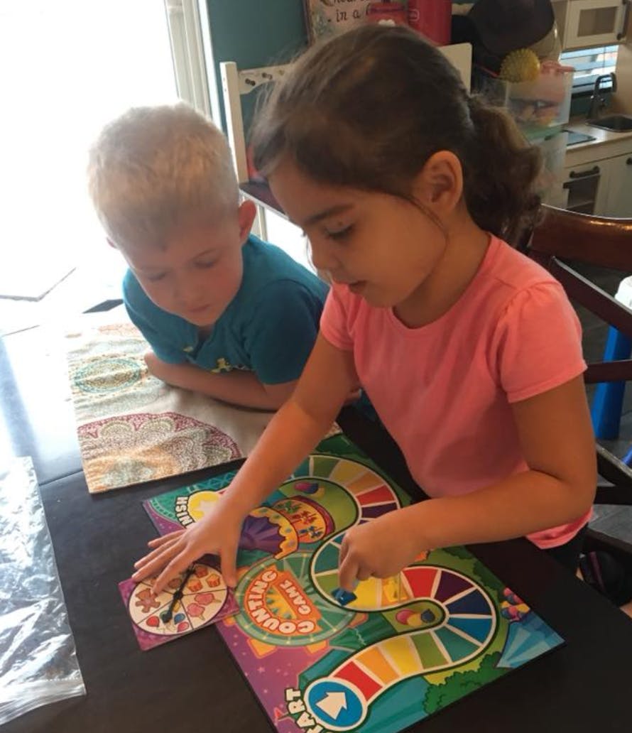 Two children playing a board game