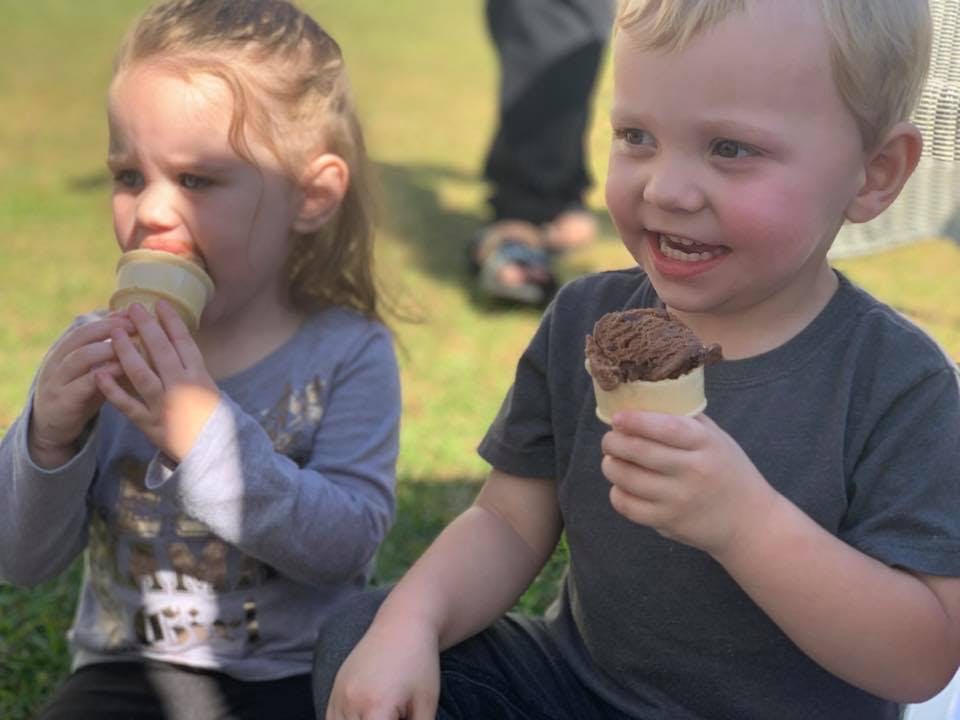 Two children eating ice cream cones