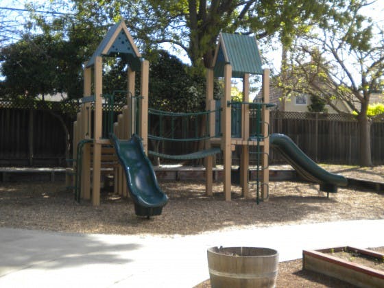 Playground structure with slides and climbing nets