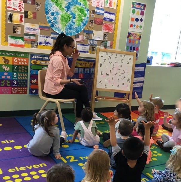 Person teaching children in a classroom