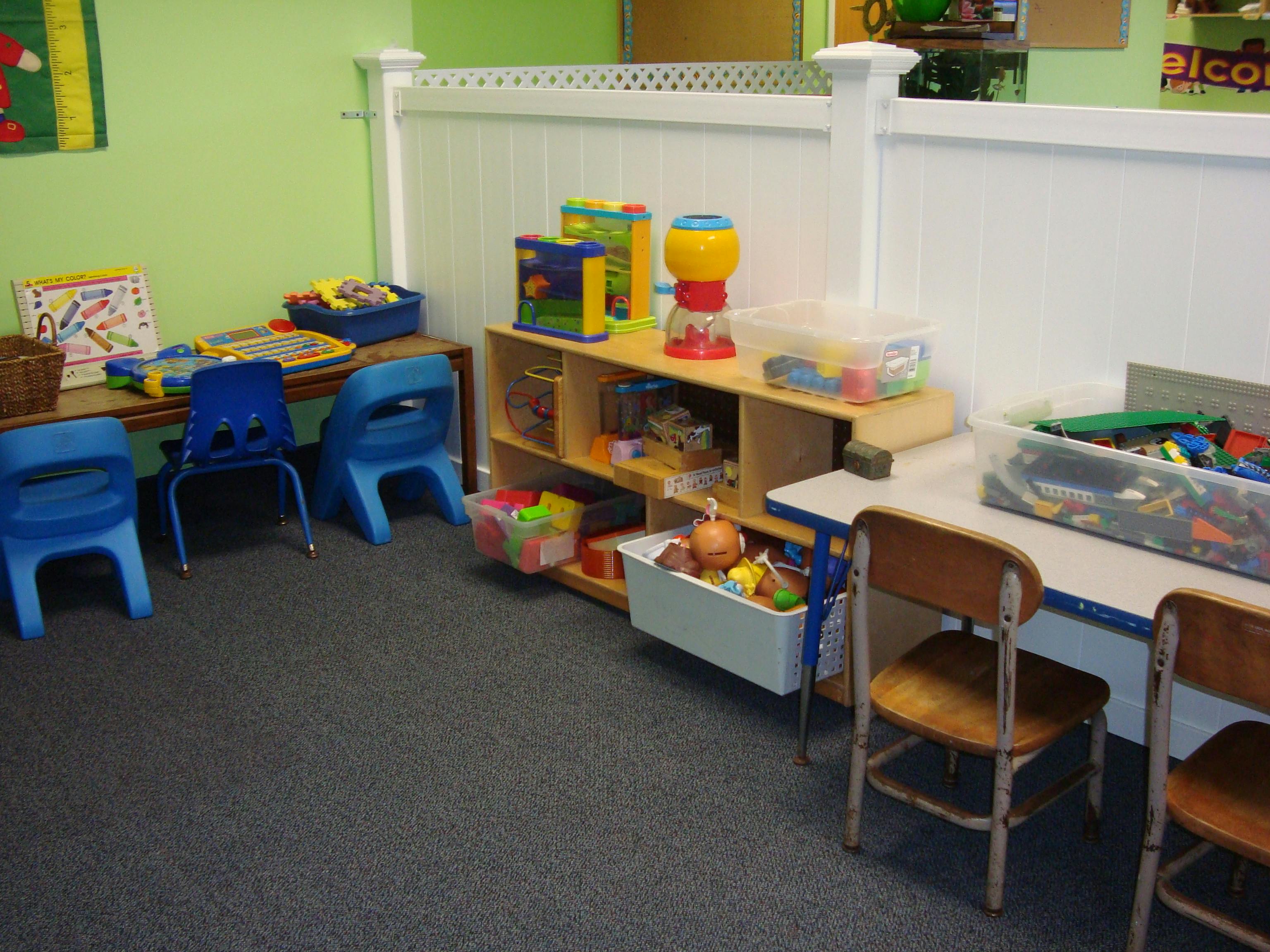Classroom with small chairs and shelves of toys