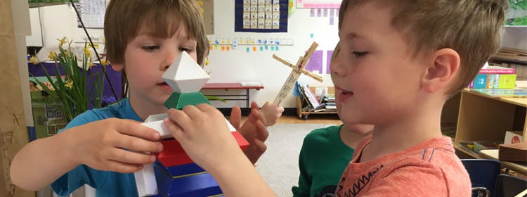 Two children playing with colorful building blocks