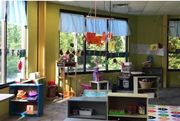 Classroom with large windows and various shelves and toys