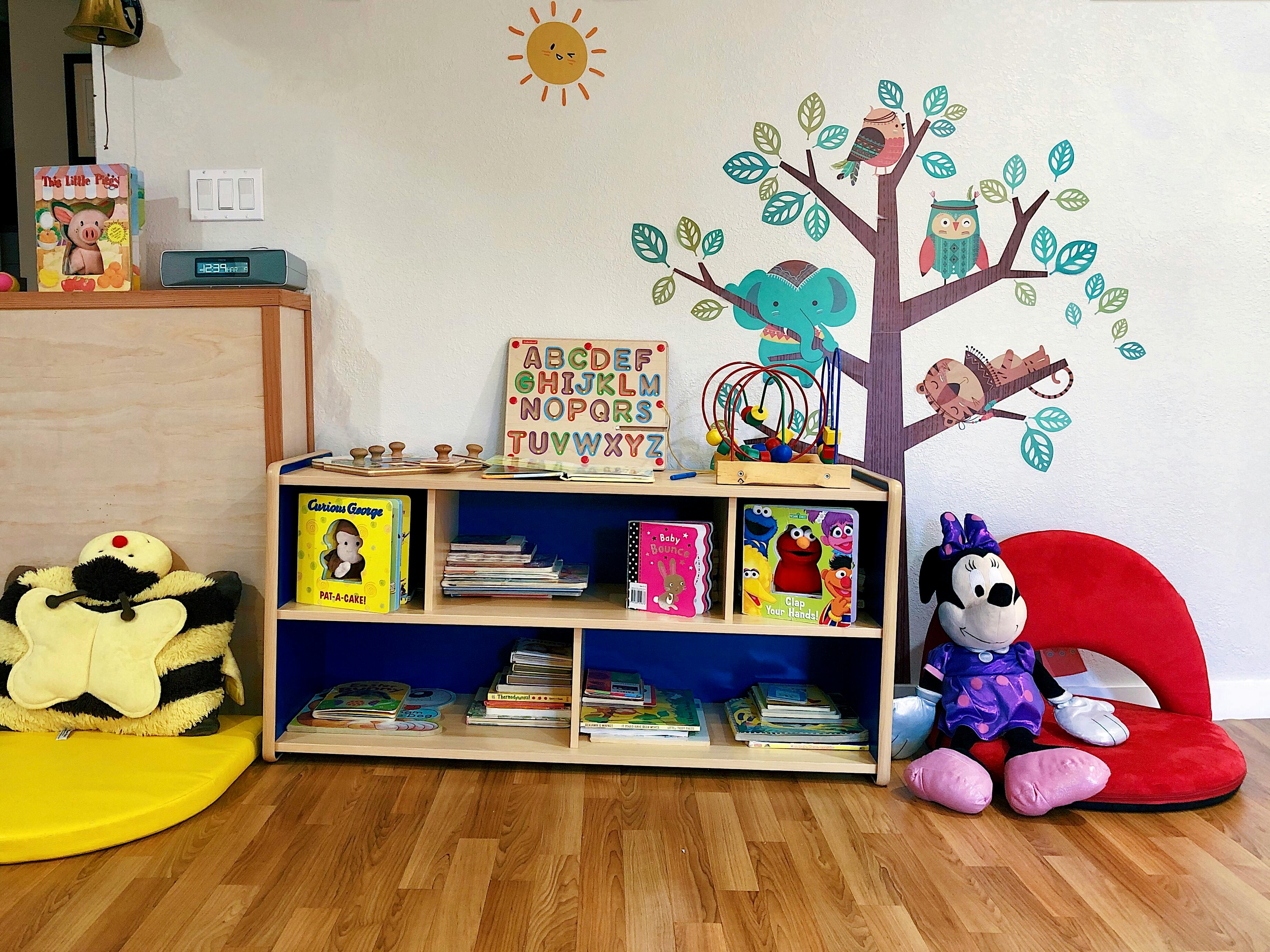 Children's bookshelf with books, toys, and a Minnie Mouse plush