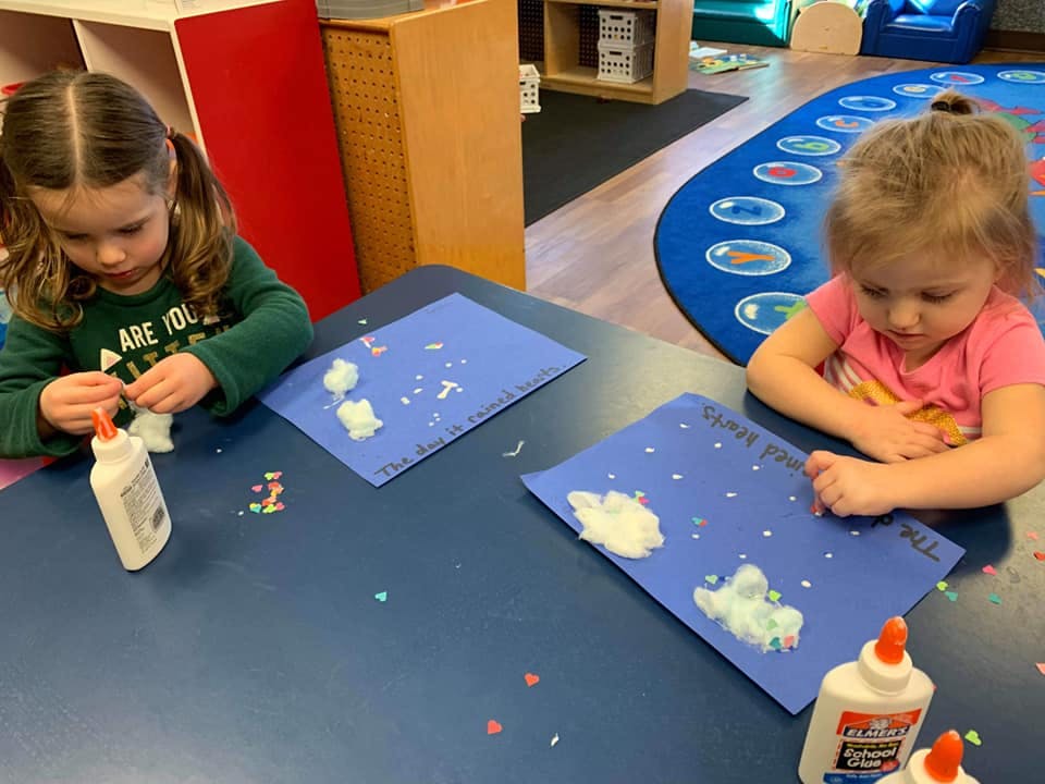 Two children doing crafts at a table