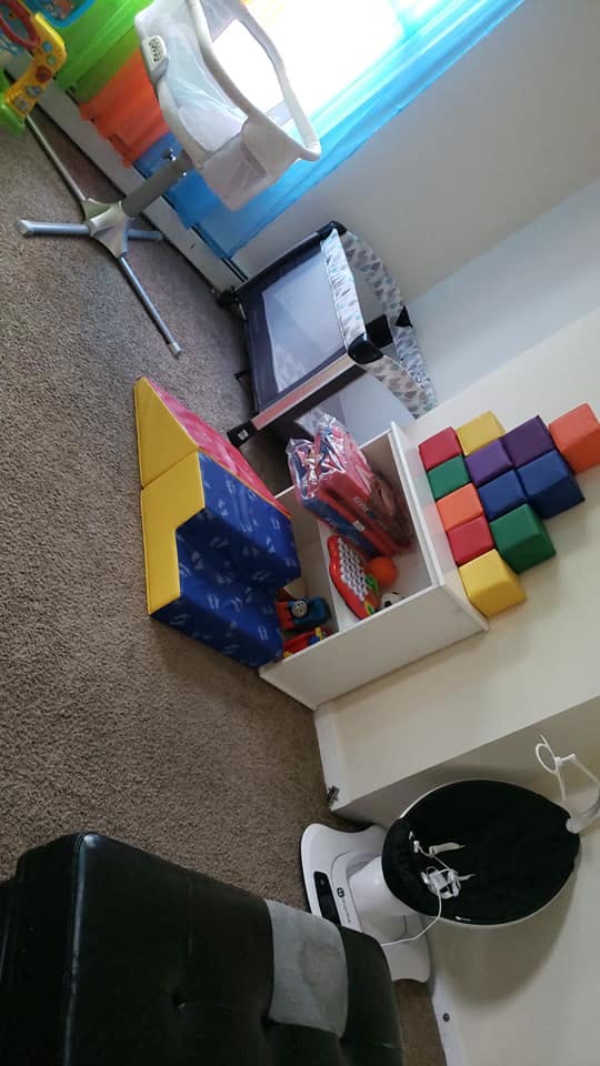 Playroom with soft play blocks, baby swing, and playpen