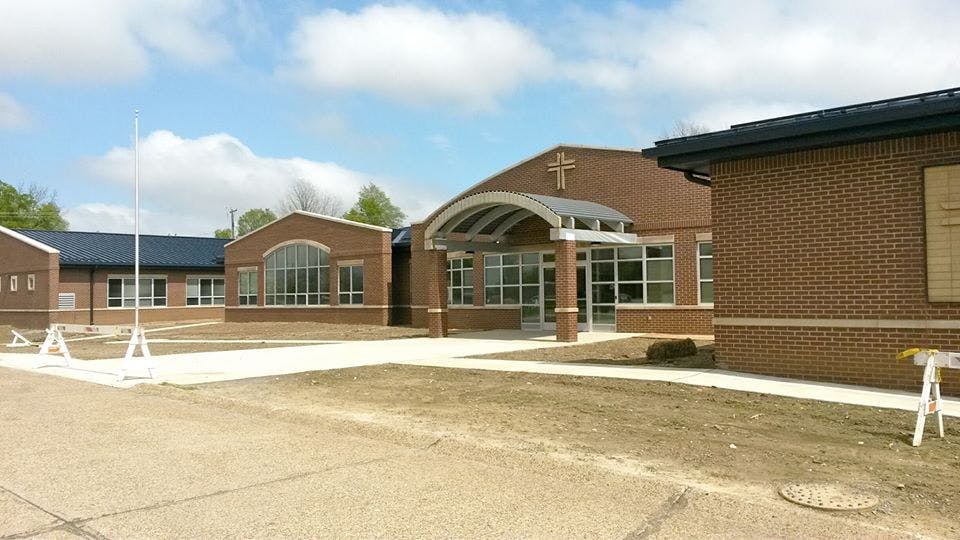Brick building with a cross above the entrance