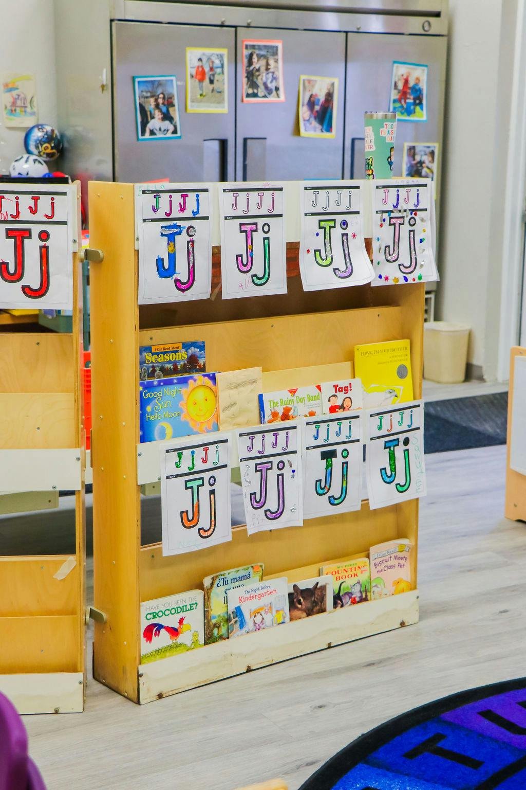 Bookshelf with children's books and alphabet cards in a classroom