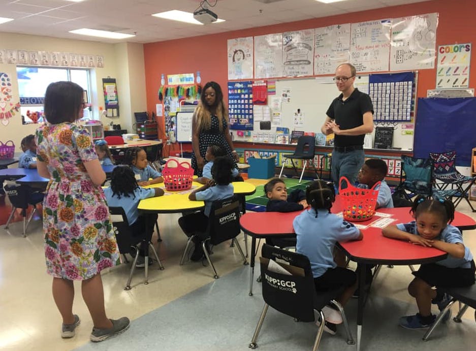 Adults and children in a classroom
