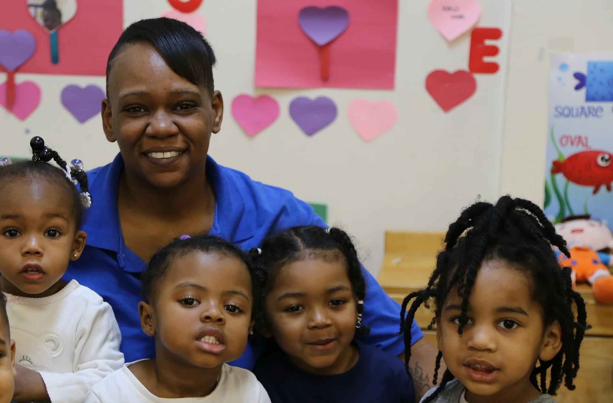 Adult and multiple children in a classroom