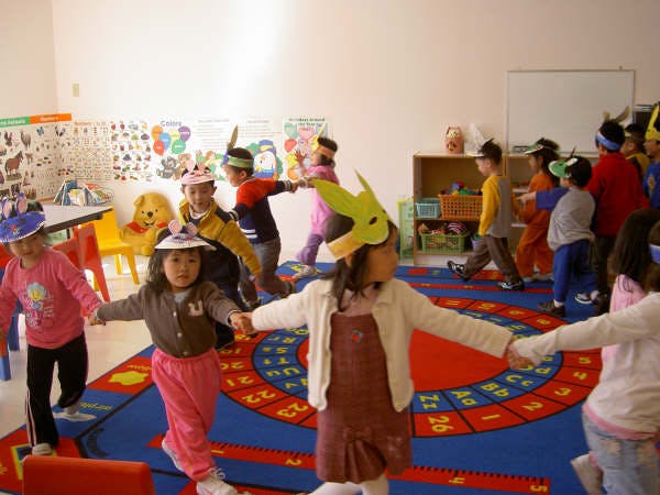 Children holding hands in a classroom