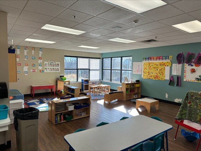 Classroom with various learning stations and artwork on the walls