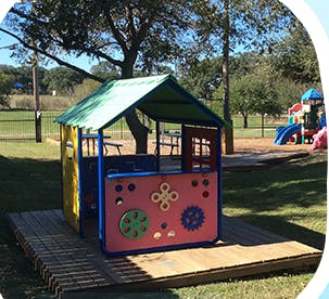 Playhouse on a wooden platform at a park