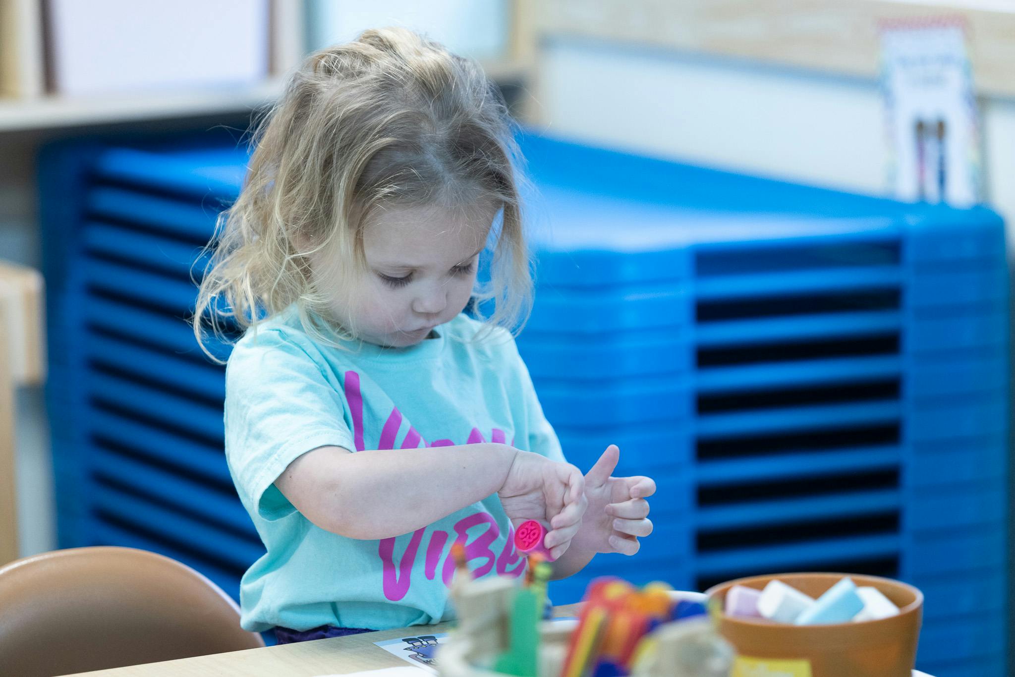 Child playing with craft materials at a table