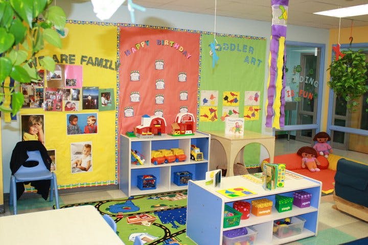 Colorful classroom with toys, shelves, and bulletin boards