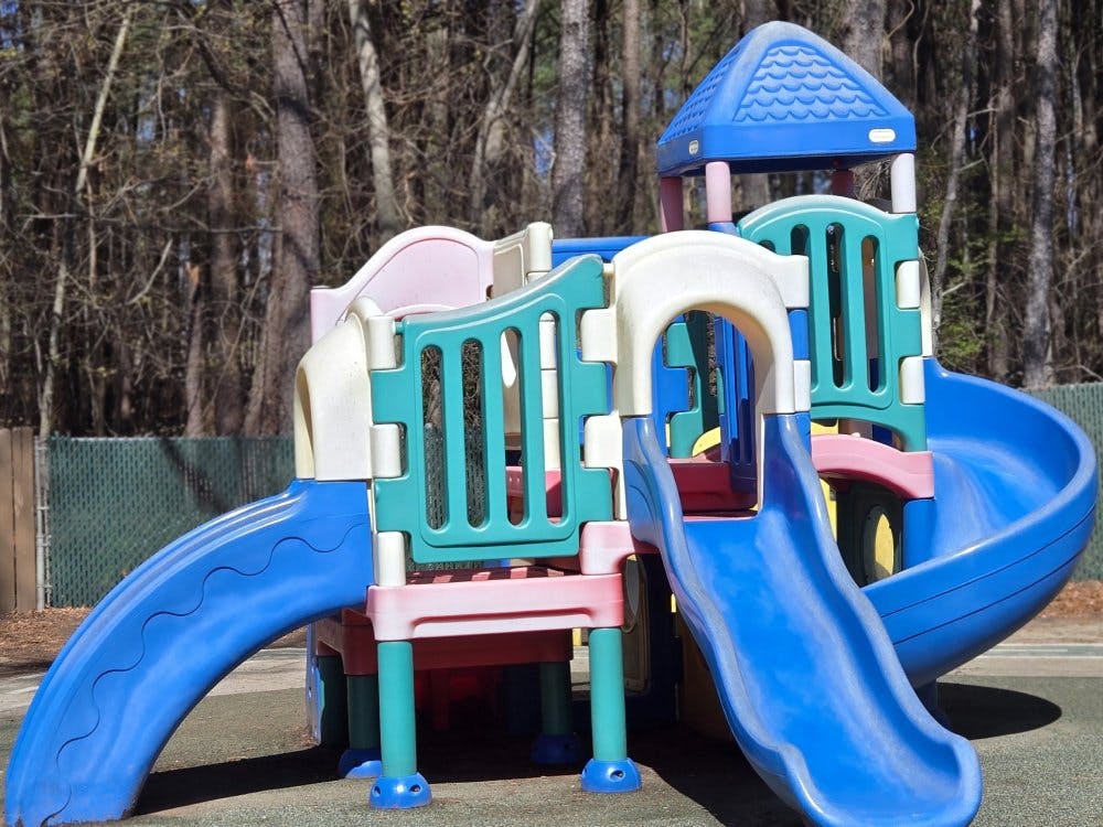 Colorful playground structure with multiple blue slides