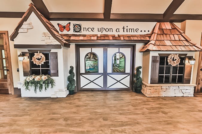 Playhouse with "once upon a time..." written above the door