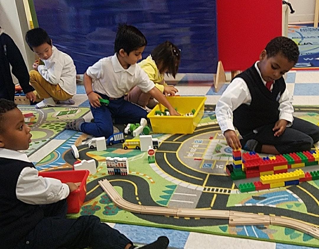 Children playing with blocks and toys on a rug