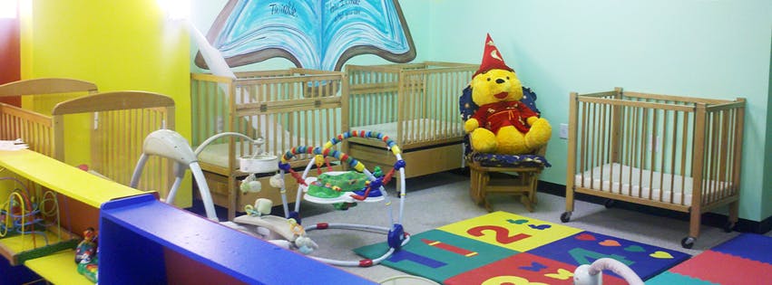 Cribs and play area in a childcare room