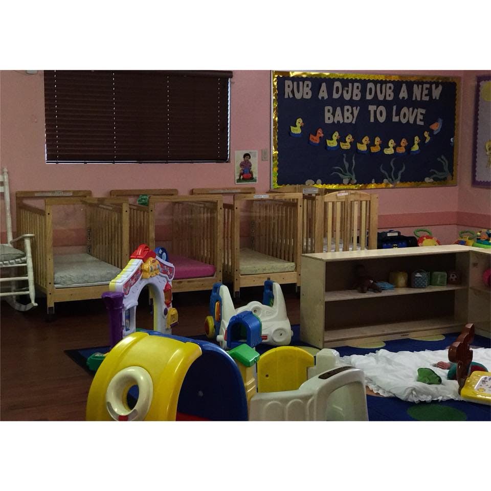Nursery room with multiple cribs and children's play equipment