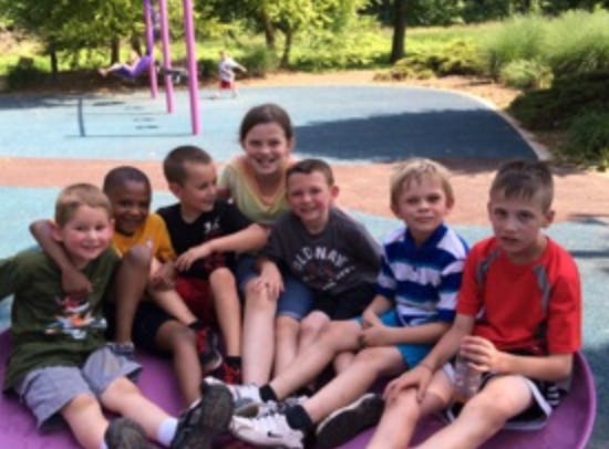 Group of children sitting together outdoors
