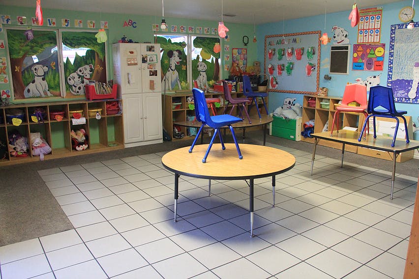 Empty classroom with small tables and chairs