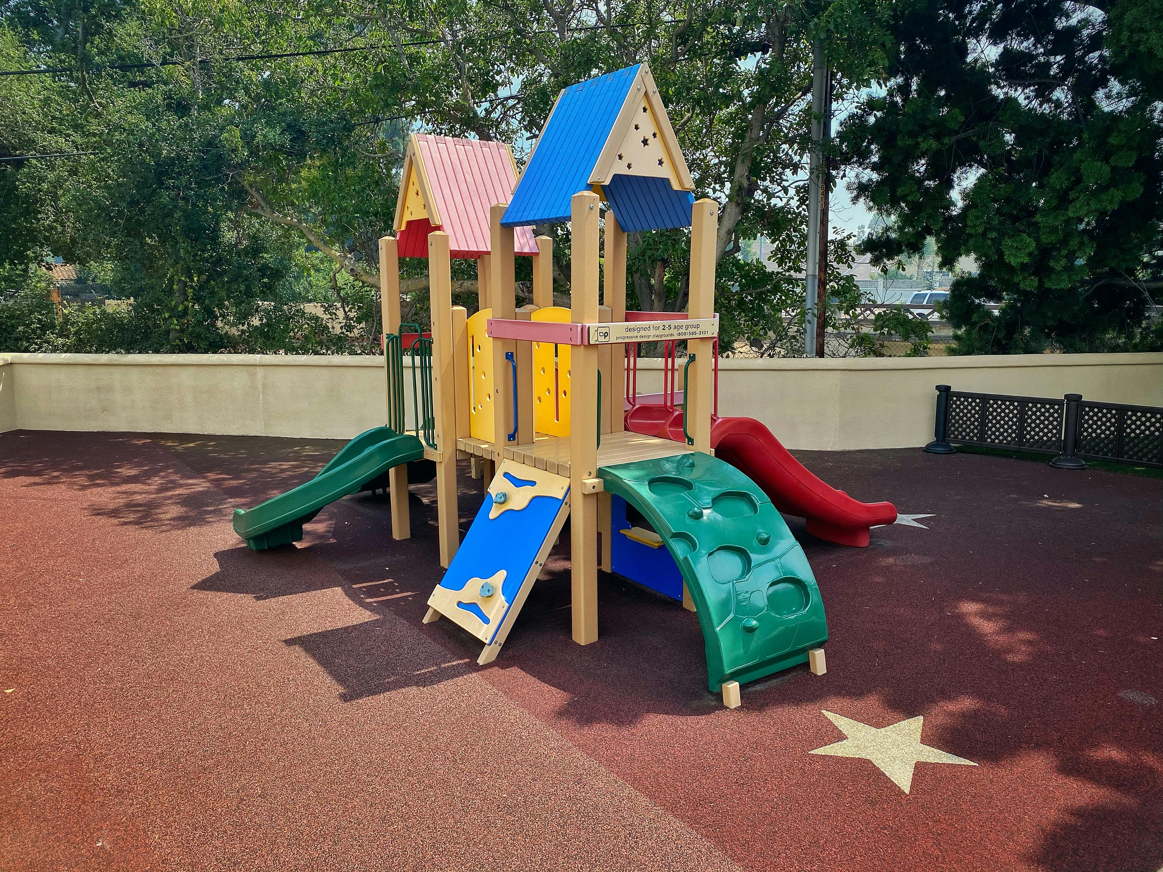 Playground structure with slides and climbing features