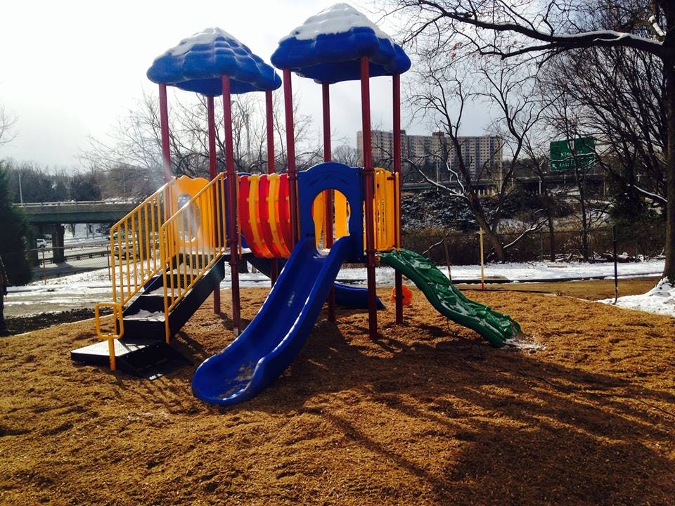 Playground structure with slides and stairs on wood chips