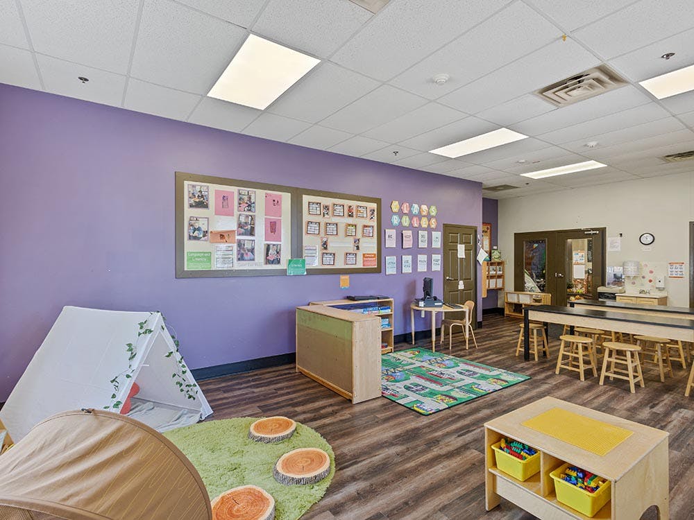 Children's classroom with purple wall, tent, and tables