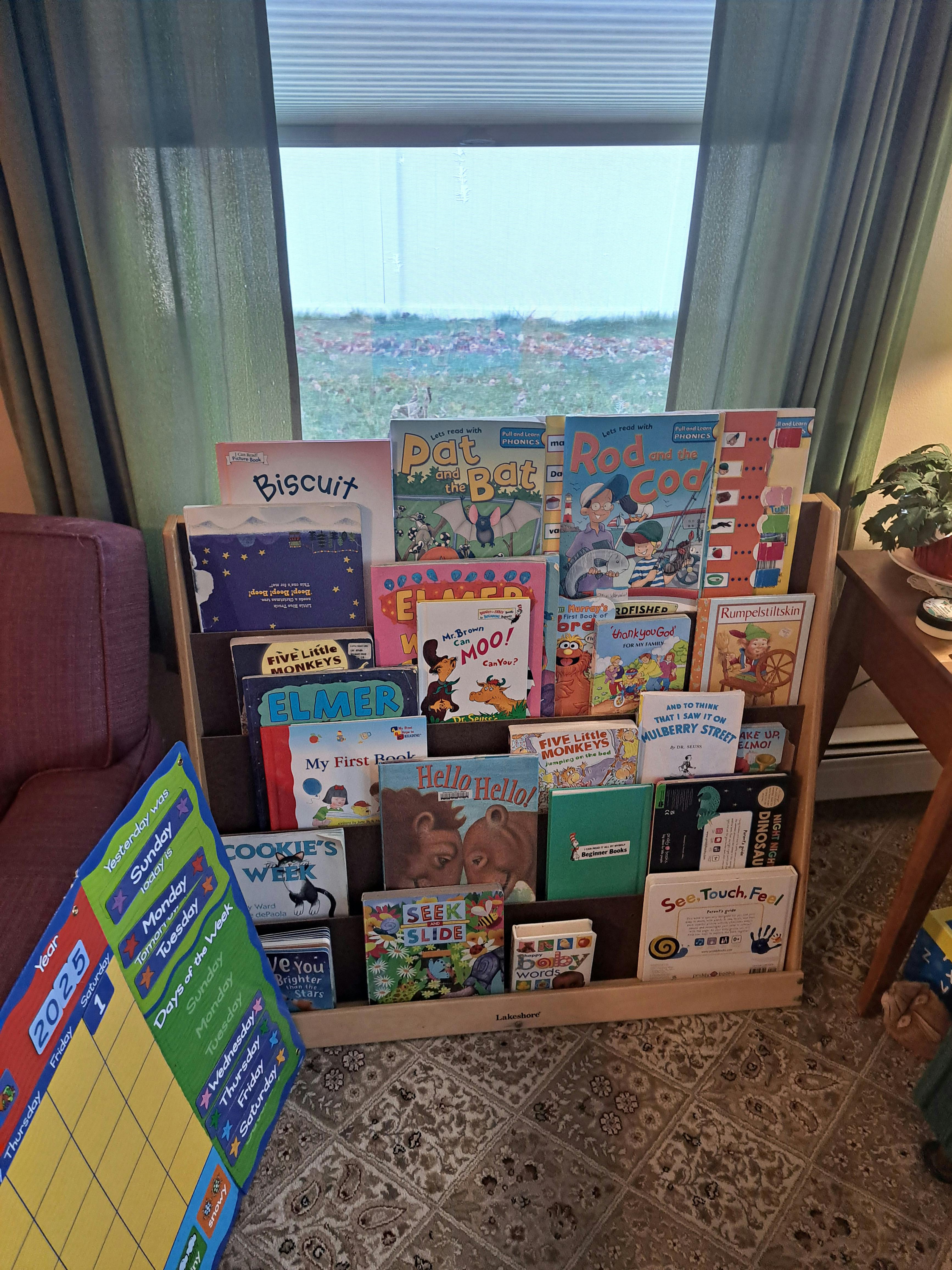 Children's books displayed on a wooden bookshelf