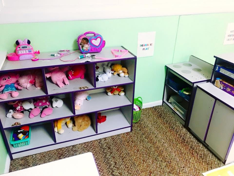 Shelves with stuffed animals and toys in a classroom